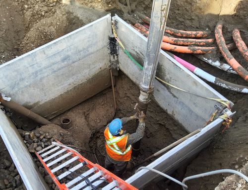 Worker uses hydrovac to expose utilities