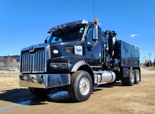 A black hydrovac truck