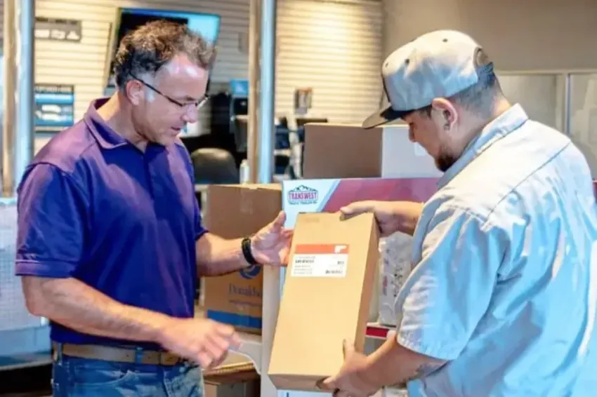 Two men check a package inside a store